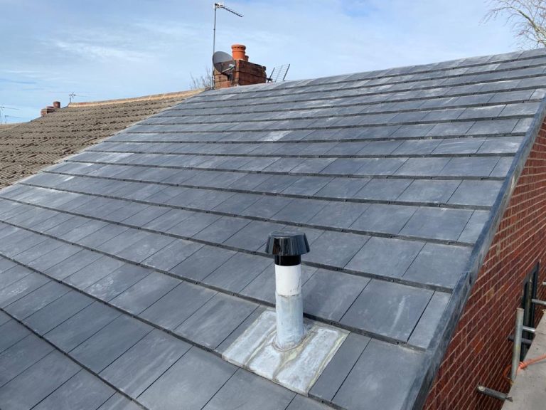 Grey tiled roof with a new vent pipe