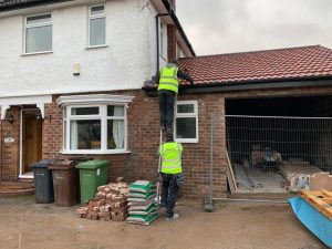 Roofer & Builder team on ladders during a house extension project