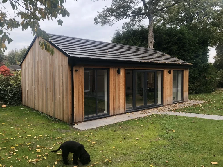 Timber-clad garden room built on a lawn
