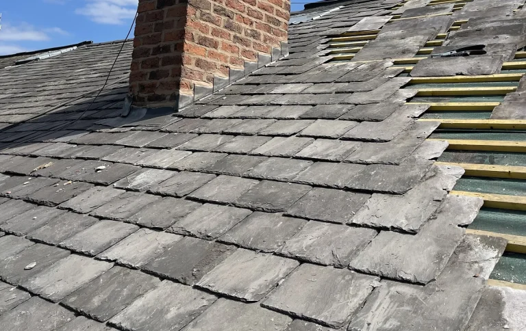 Slate roof with a brick chimney stack