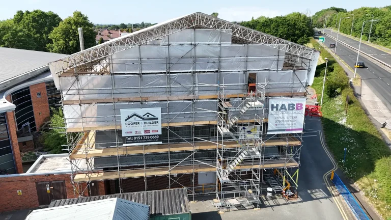 Building under scaffolding with Roofer & Builder site banners